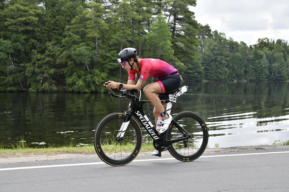 Mathilde, athlète de perfattitude, sur un vélo avec une tenue de cycliste participant à l'Ironman 70.3 de Muskoka au Canada